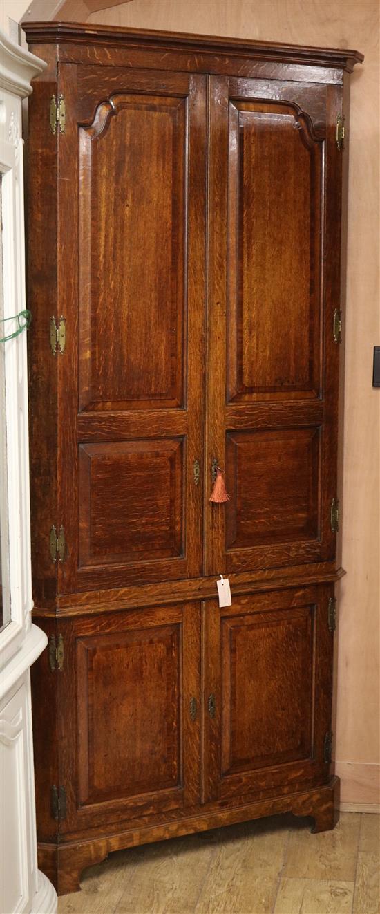 A George III oak standing corner cupboard W.100cm
